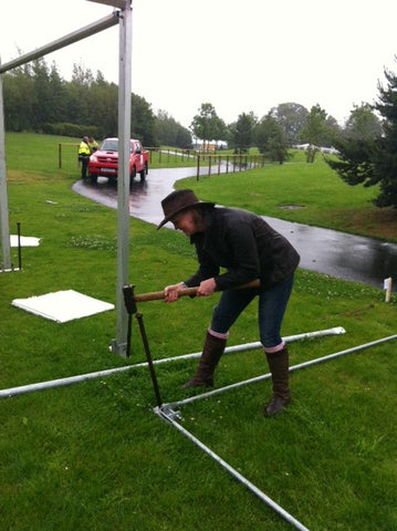 Alex trying to hammer in a marquee pole!