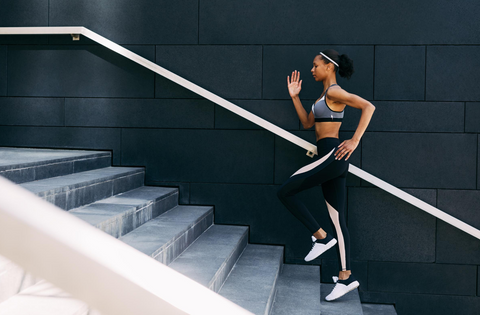 Woman-running-stairs-to-boost-energy-naturally-natureal