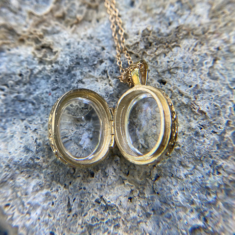 Open locket in gold with crystal stones