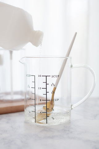 glass measuring cup with aloe, spoon