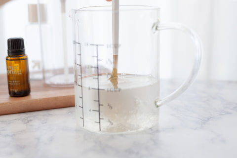 stirring alcohol and aloe to make sanitizer