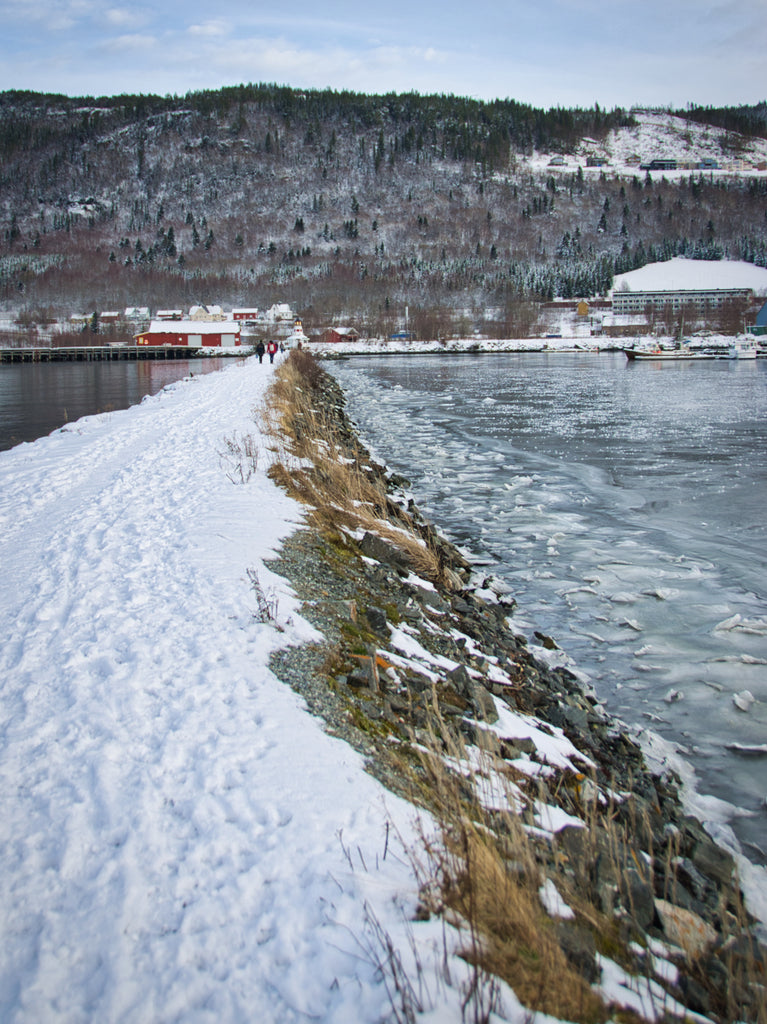 Icy harbour and distant lighthouse