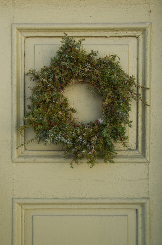 Juniper wreath on green door