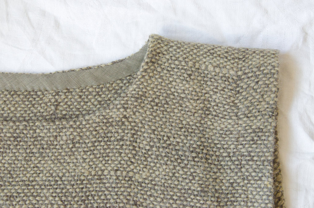 Neckline detail of hand-woven wool dress