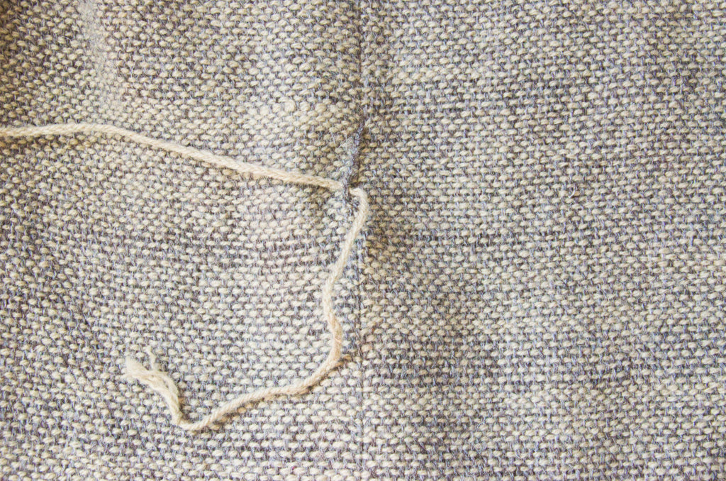 Belt loop on hand-sewn wool dress