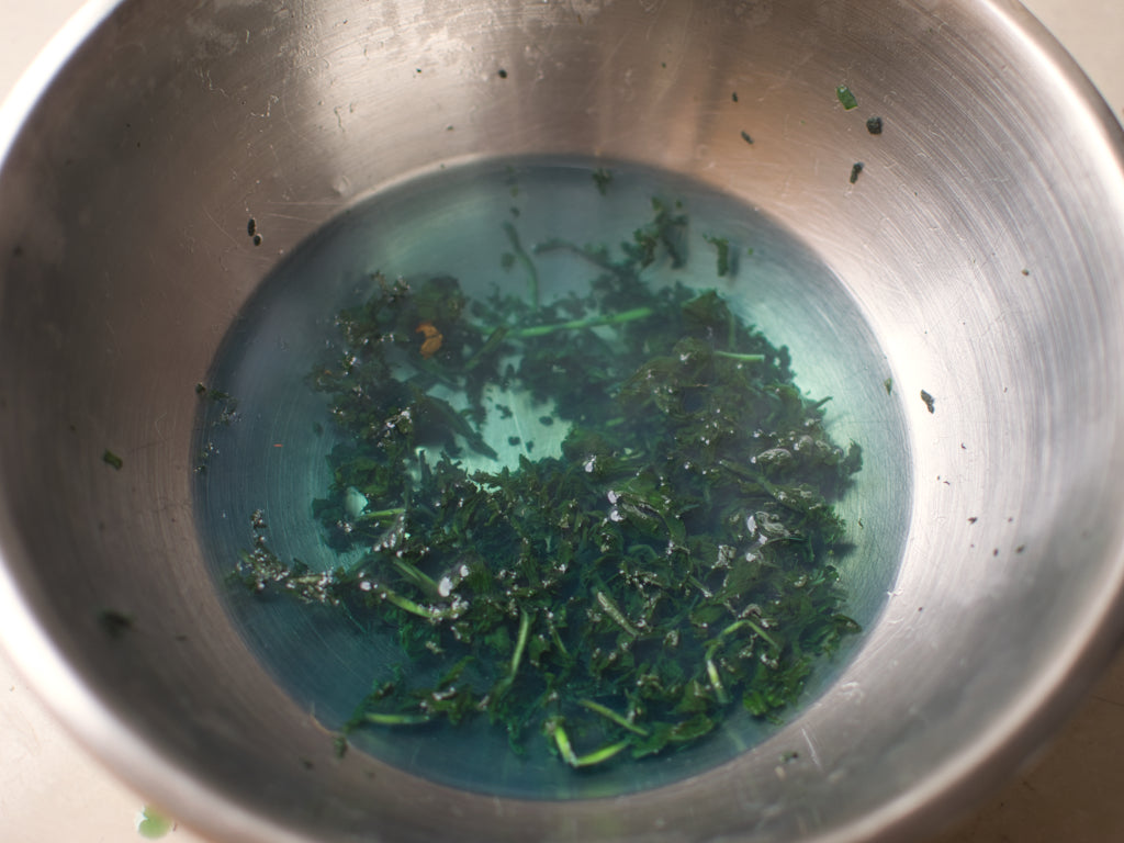 Boiling water on spent woad leaves