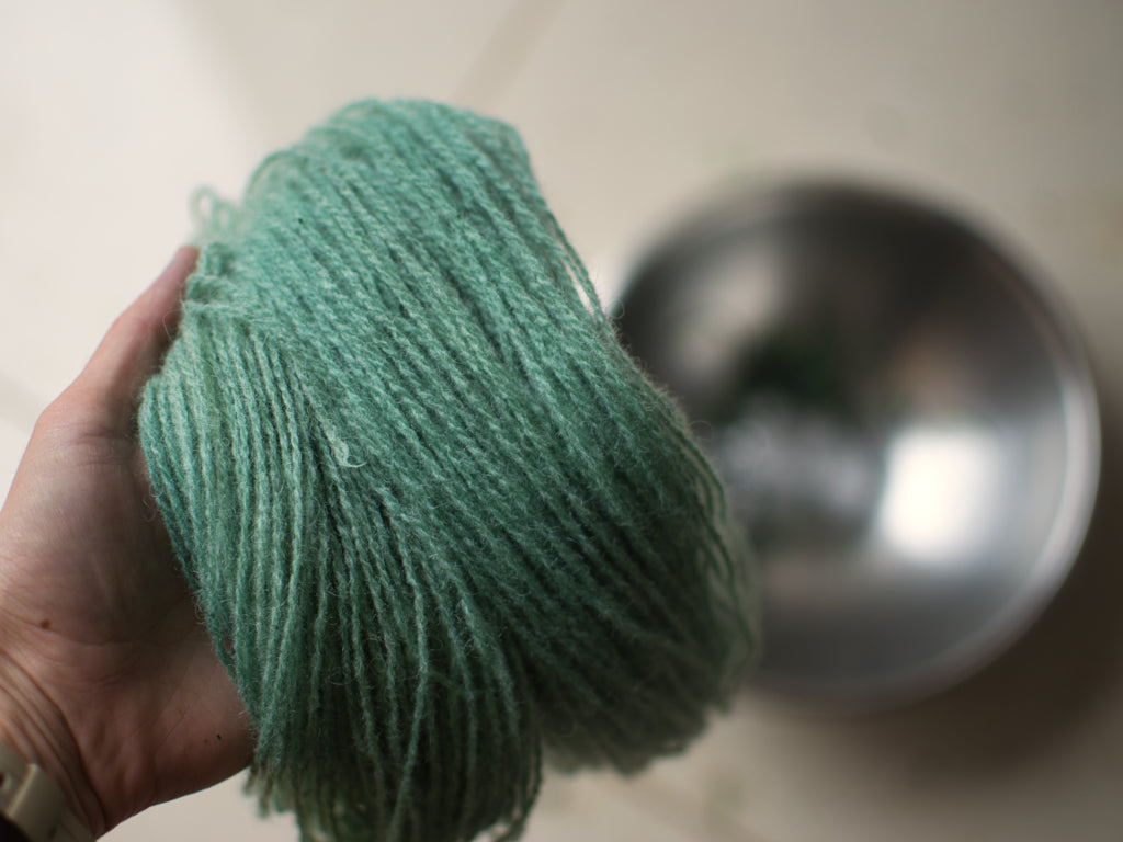 Turquoise yarn after heating woad dye