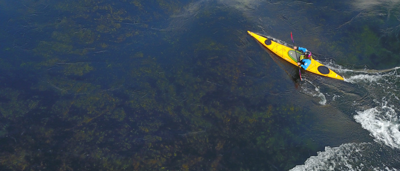 Aerial image of a sea kayaker paddling in open water