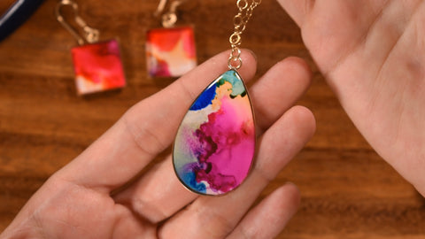 Art jewelry made with resin and alcohol ink