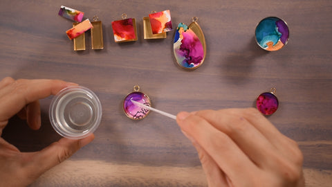 Adding resin on top of art jewelry