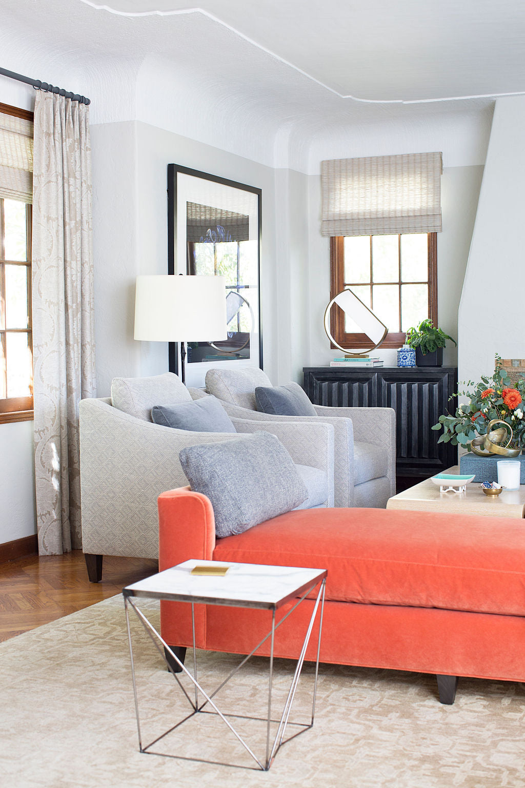 interior featuring two grey lounge chairs and salmon colored day bed