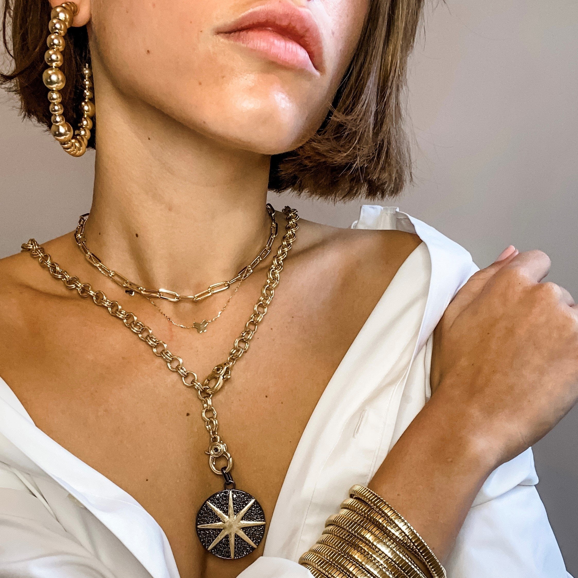 girl wearing Starburst CZ Disc Two Tone Charm Necklace • Matte Yellow & Oxidized Gold Plated • 36" Long • Pendant 1.5" Diameter