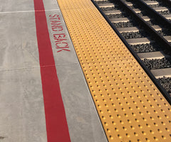 Man walking on truncated dome tile