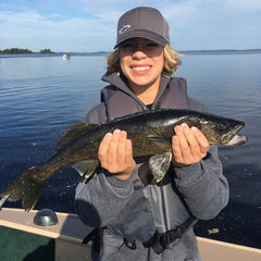 Youth in Lund boat holding dark Rainy Lake walleye - Voyageurs National Park