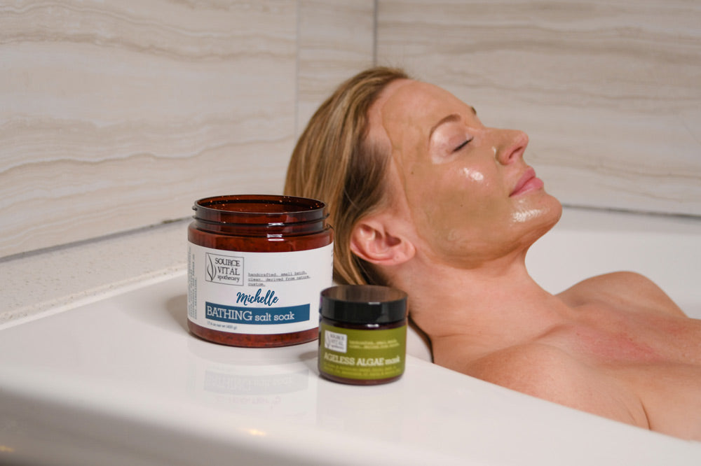 Woman taking a relaxing aromatherapy bath with custom made bath salts by Source Vital