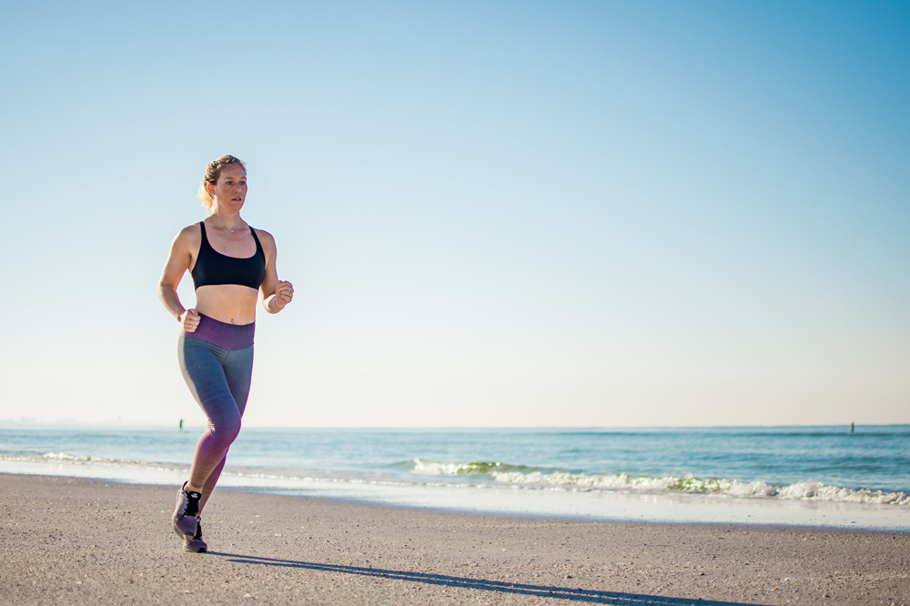 Woman running at the beach for good health