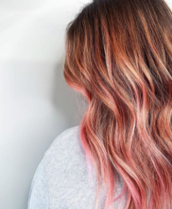 Woman with dark brown hair and pink ombre
