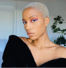 Beautiful Black woman with bleached blonde hair in a short haircut