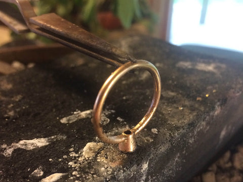 soldering a Beryllina ethical engagement ring of recycled 14K gold 