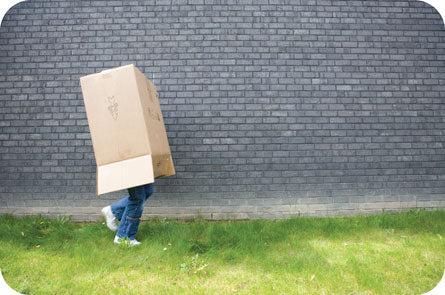 Image of person walking with box over their head.
