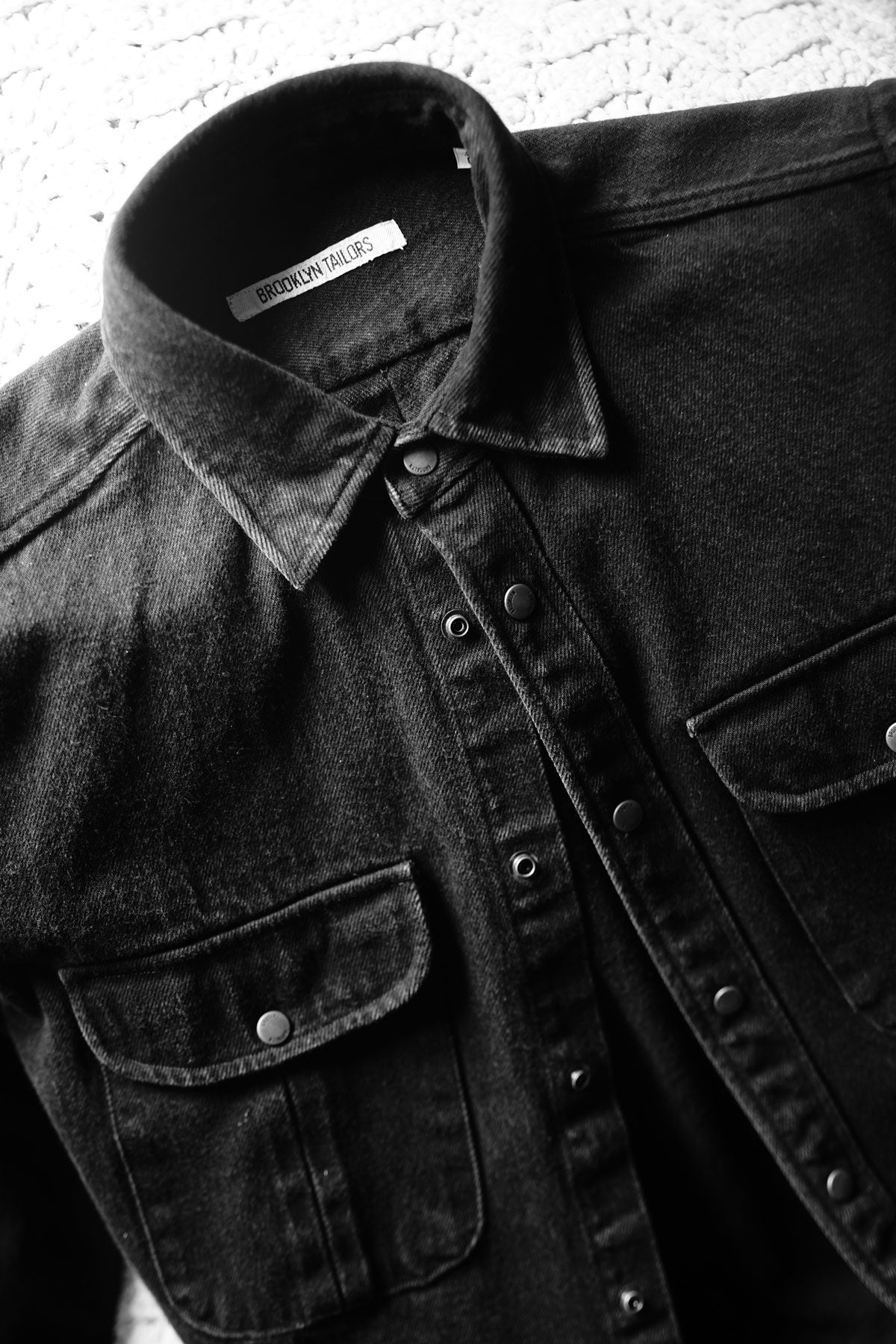 Close-up of Brooklyn Tailors denim shirt with metal snaps.