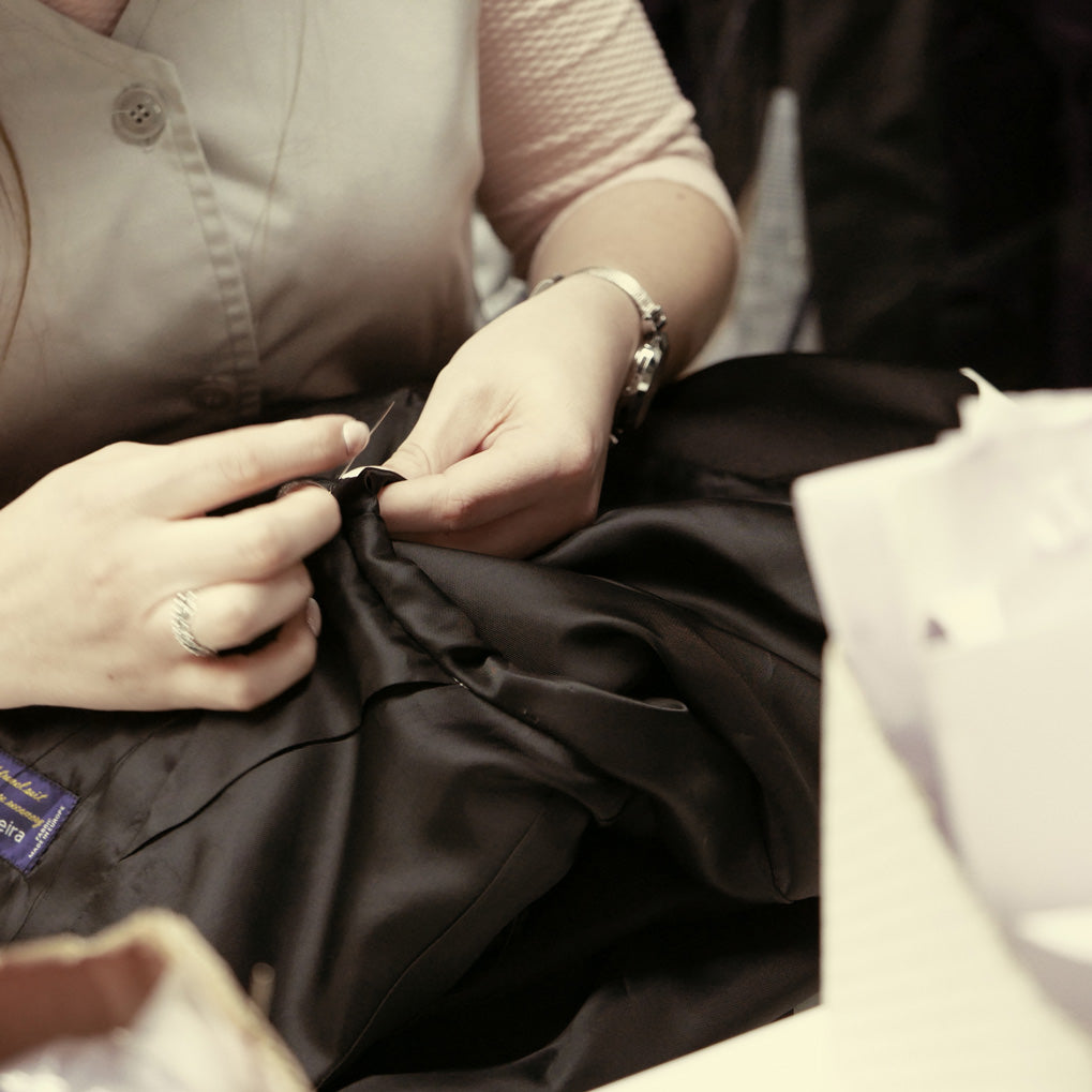 Close-up on lining being sewn into a jacket.