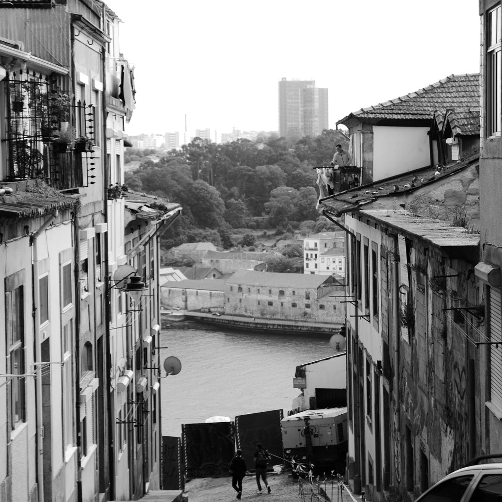 Black and white photo of Porto from a hill overlooking the river.