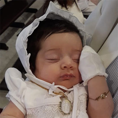 baby with Virgin Mary medal