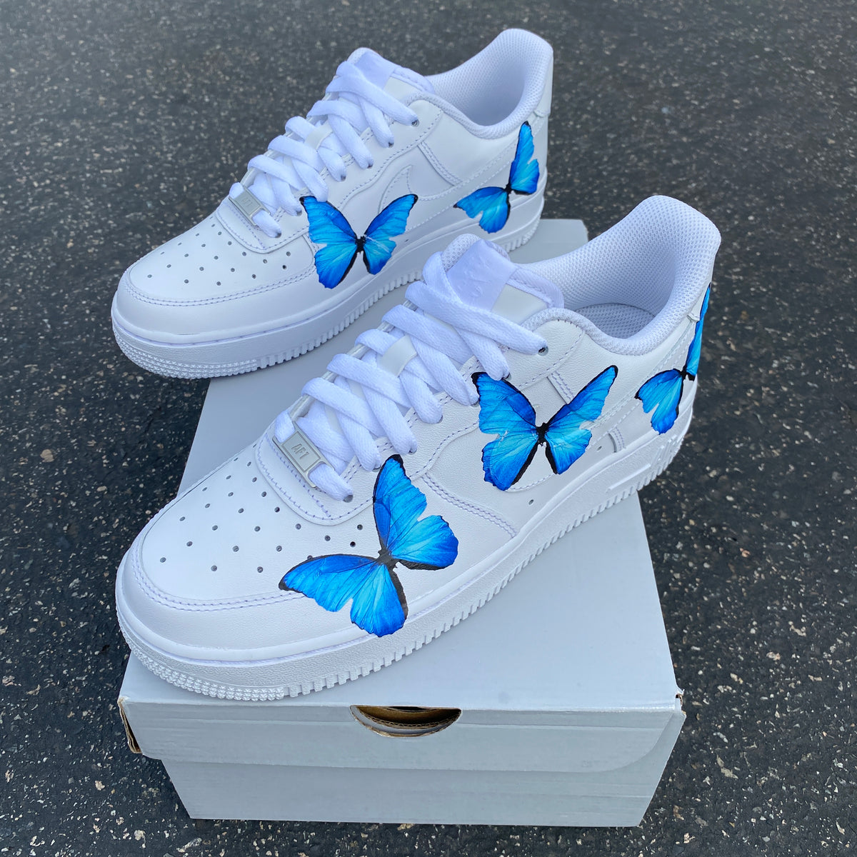 white nike air forces with blue butterflies