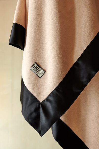 Close up of the super luxurious black silk borders on the camille luxury throw and blanket