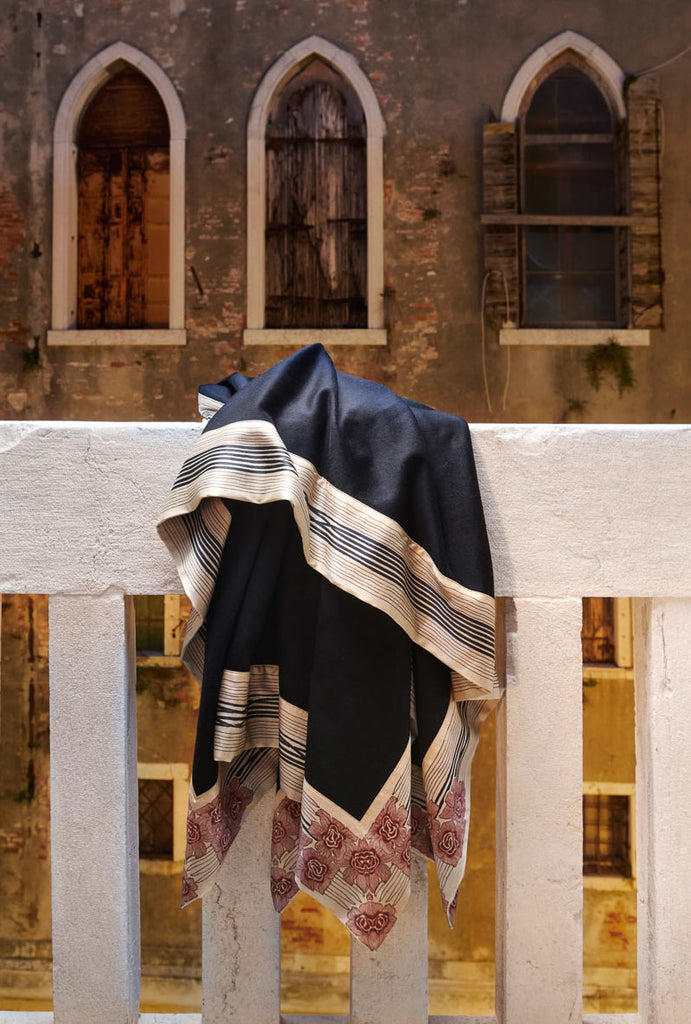 now voyager luxury cashmere blanket with beautiful patterned pure silk borders hanging off a balcony