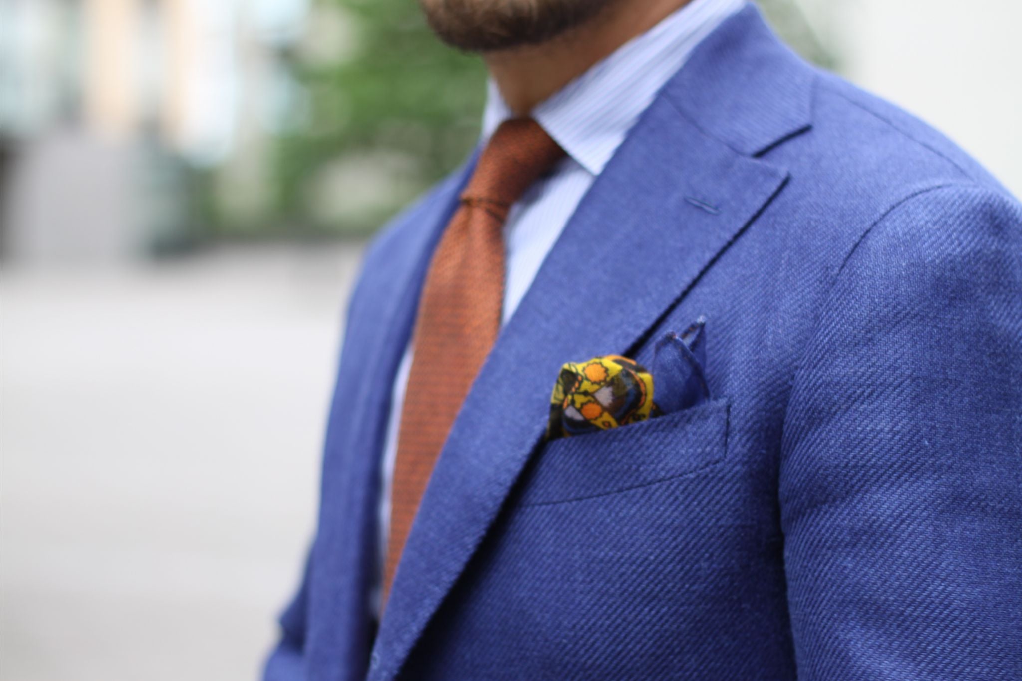 Blue suit with orange tie and pocket square