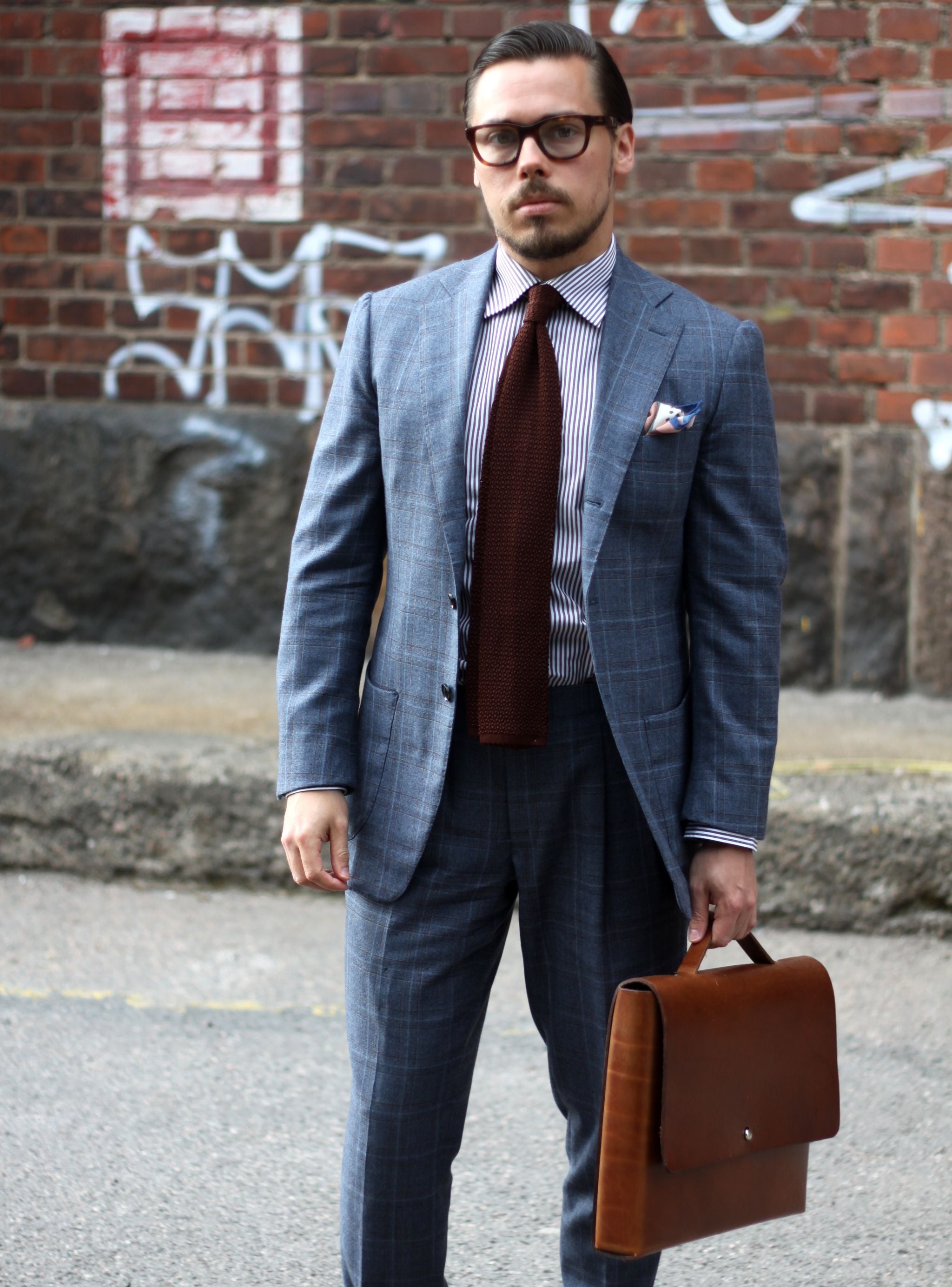 Brown knit tie with suit and striped shirt