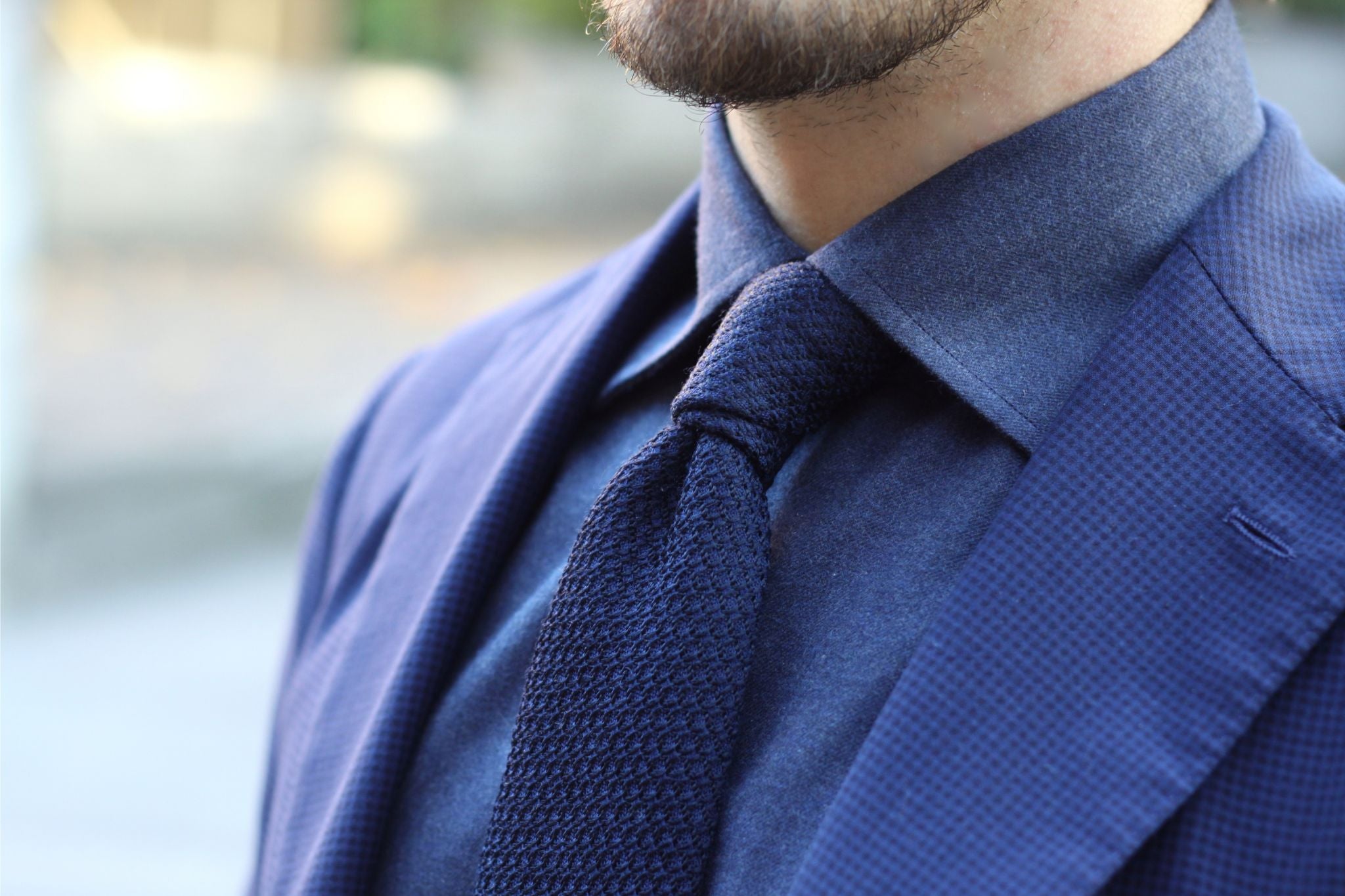 Dark blue grenadine tie with a seersucker sport coat