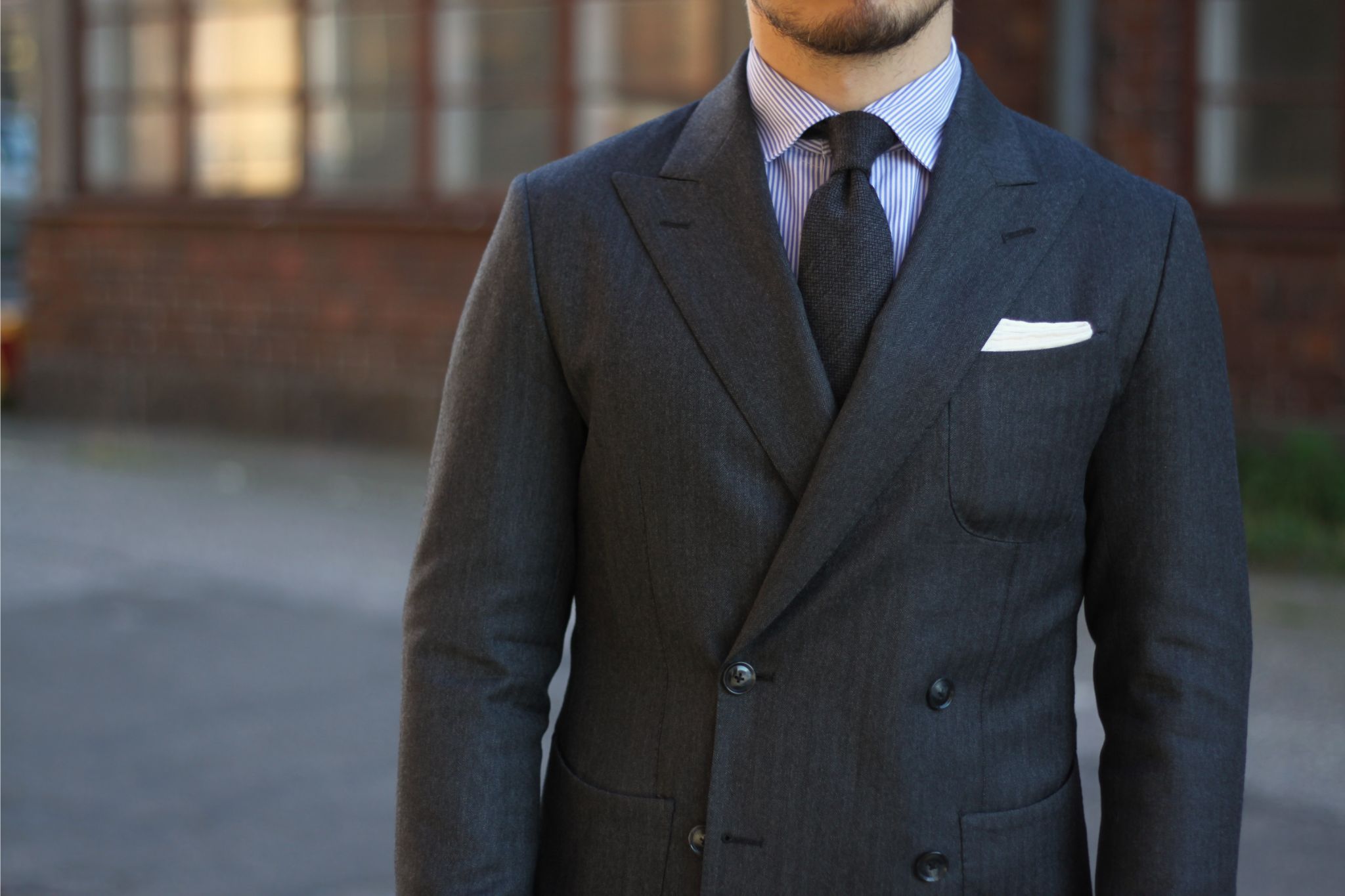 Gray double-breasted suit with a gray tie