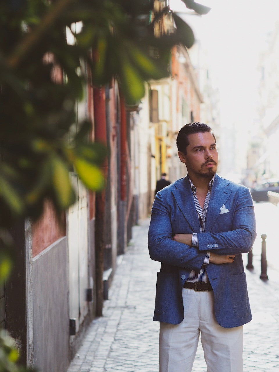 Light blue suit jacket with striped shirt and white linen trousers