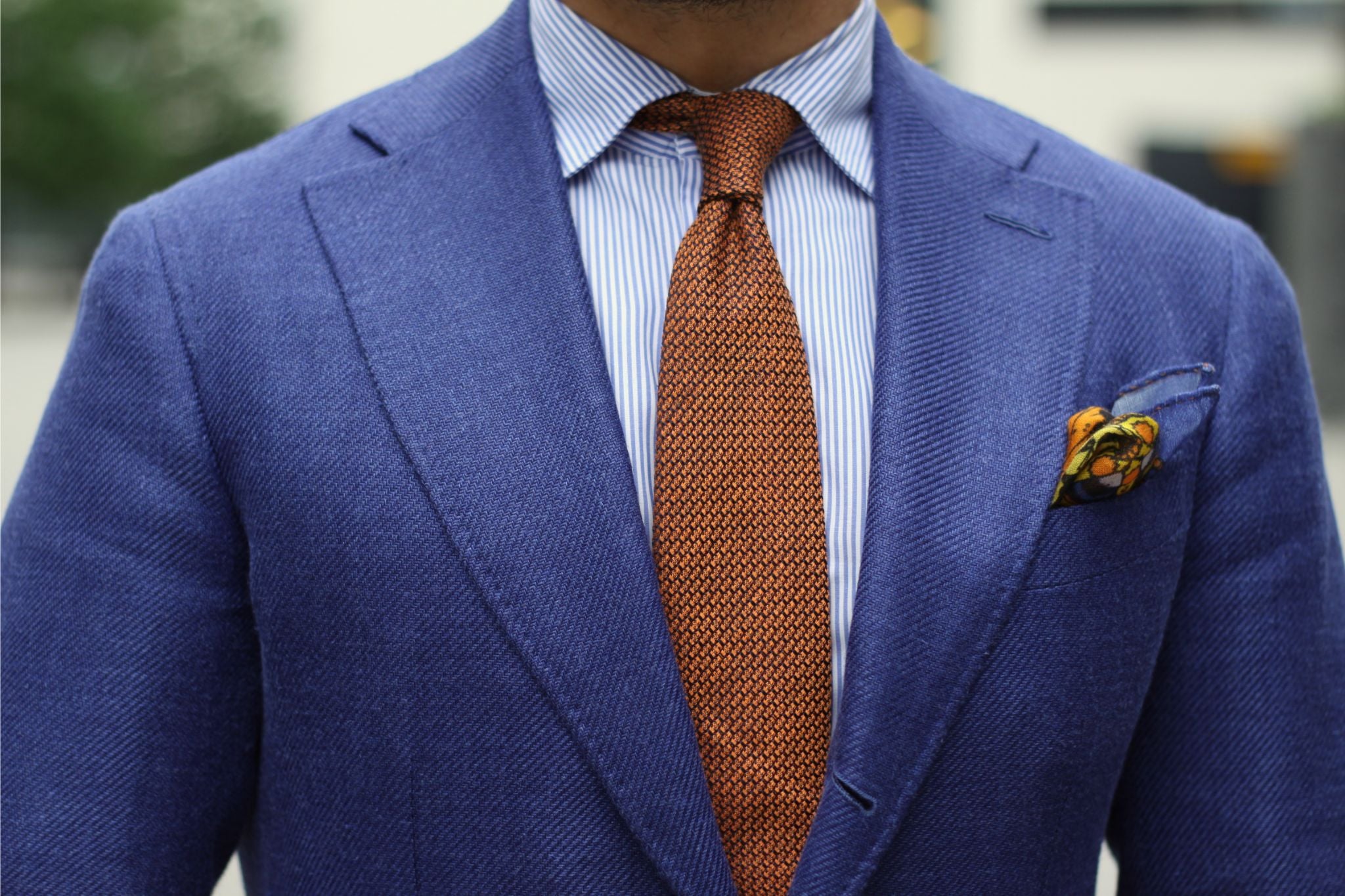 Orange tie with blue suit - close-up