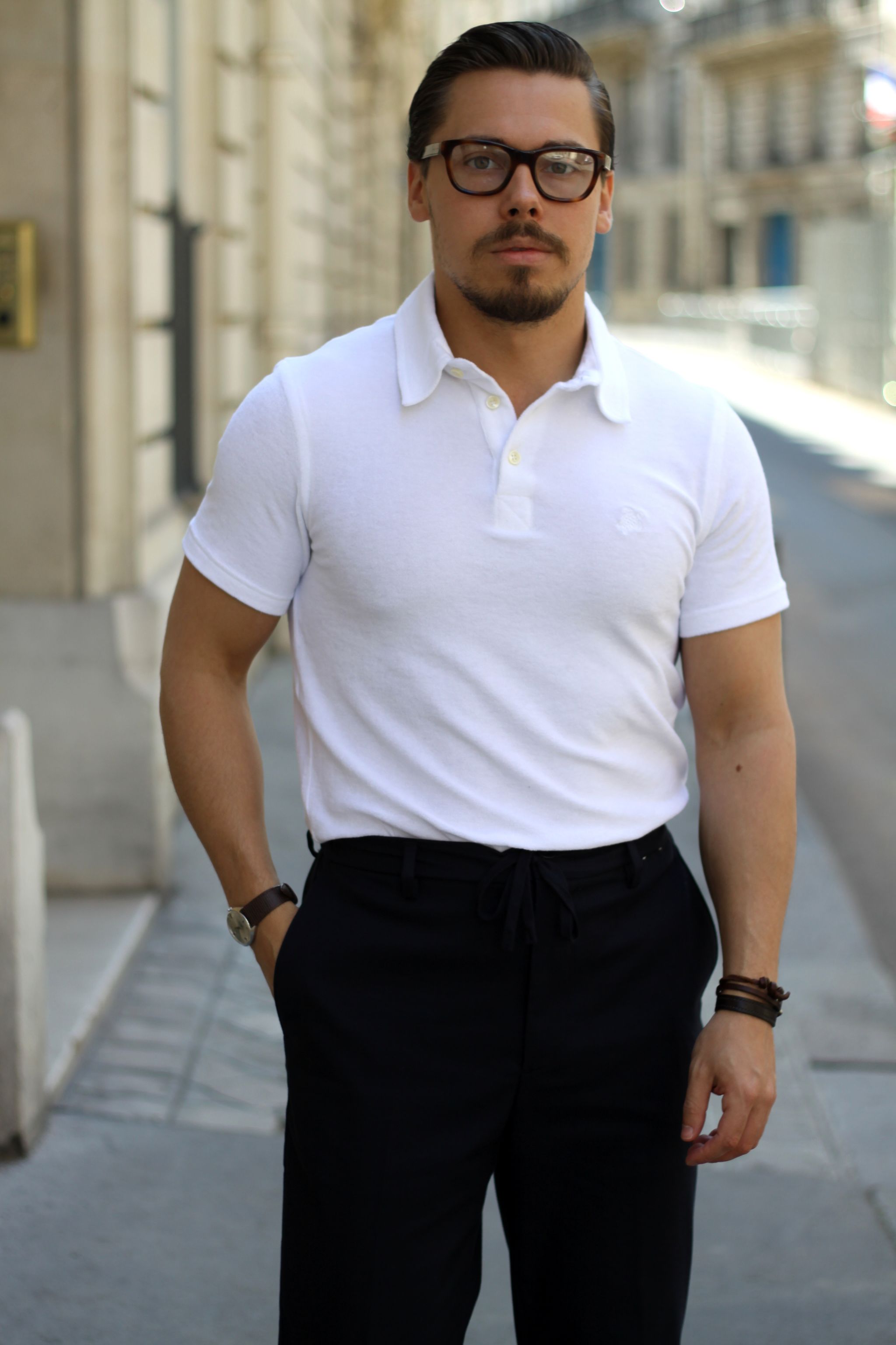 White toweling cloth polo shirt with dark blue trousers