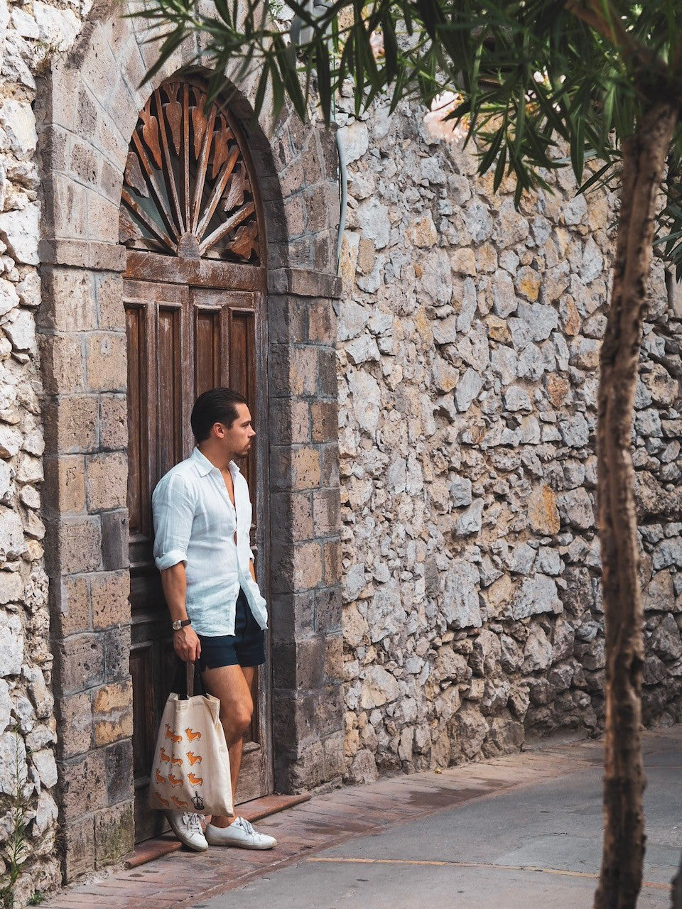 White linen shirt with navy blue shorts and superga sneakers