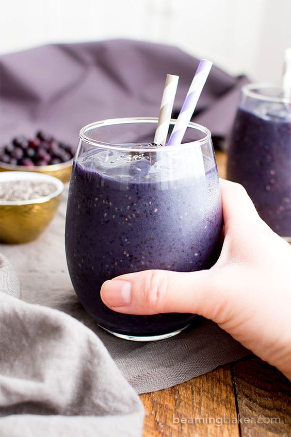 Hand holding Paleo Blueberry Banana Chia Smoothie for a Low Carb Breakfast