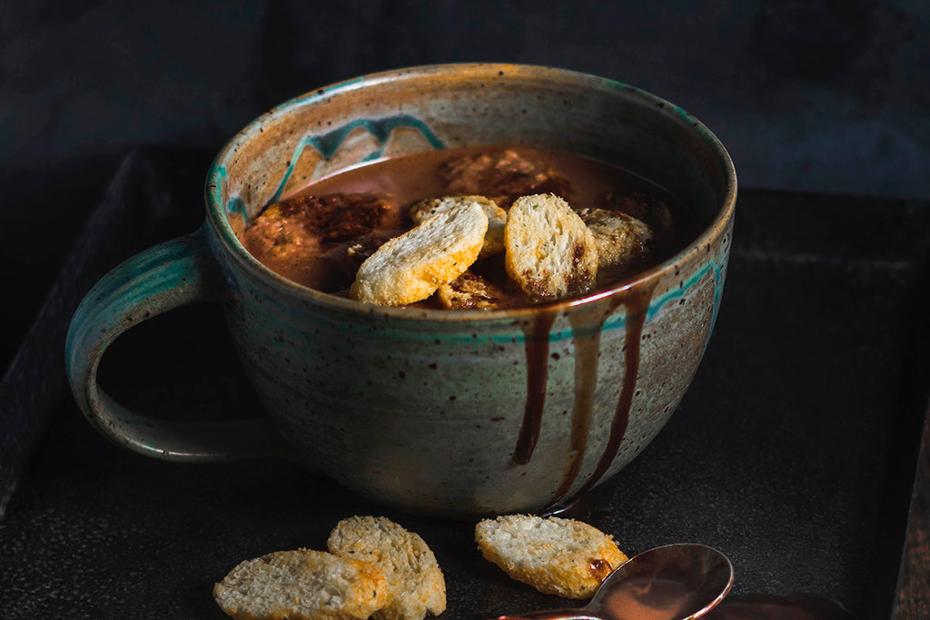 Mug with melted chocolate spilling over the edge