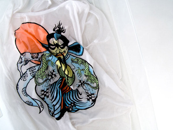 screen-printed shirt soaking in a clear plastic tub