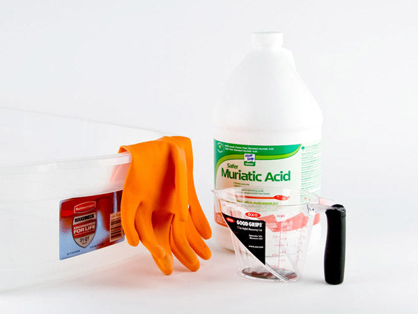 clear plastic tub, rubber gloves, a bottle of muriatic acid, and a plastic measuring cup