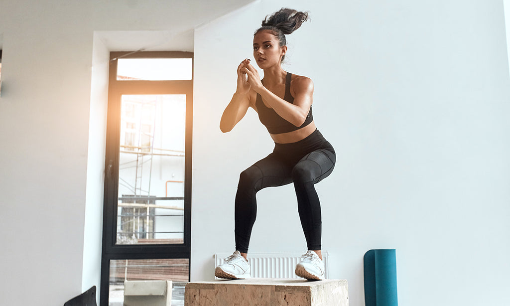 Woman performing bodyweight squat jump