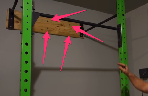 Lag screws holding a stringer for a pull-up rig to a wall