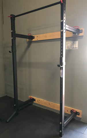 A retractable squat rack installed with two stringers