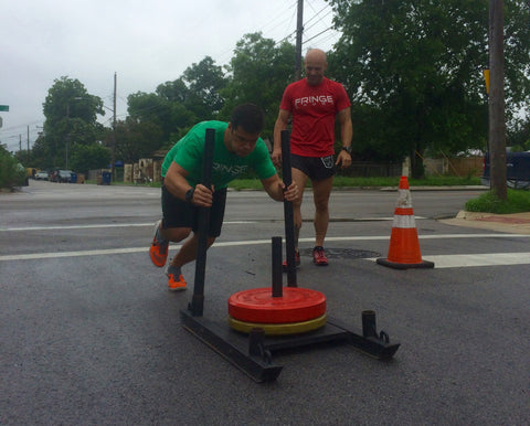 Weight on a prowler sled - pushing at Atomic Athlete