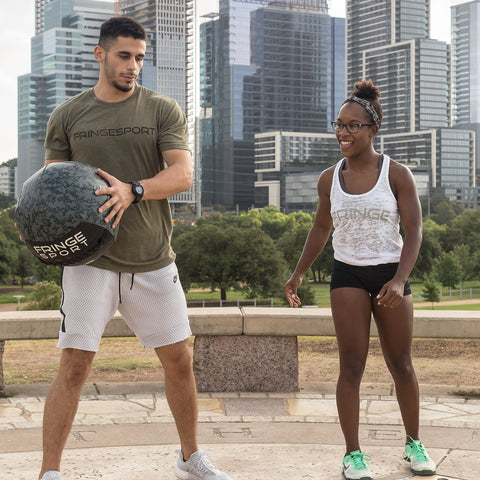 man and woman with medicine ball