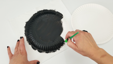 Black paint on paper plate
