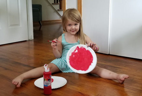 Child with Red Paint and Paper Plate